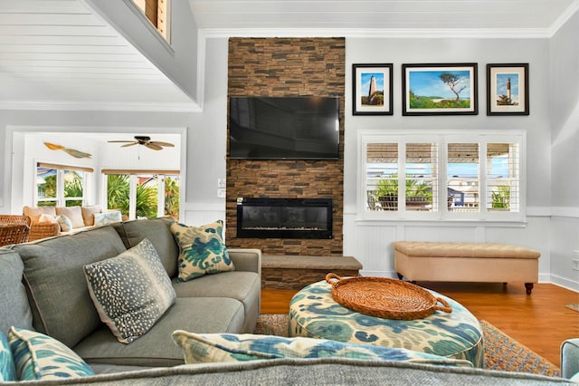 39 Newport St, Ocean Isle Beach, NC 28469 - living area featuring wood finished floors, crown molding, plenty of natural light, a fireplace, and a wainscoted wall