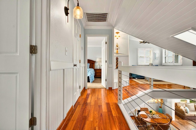 39 Newport St, Ocean Isle Beach, NC 28469 - hallway featuring ornamental molding, light wood finished floors, and wainscoting