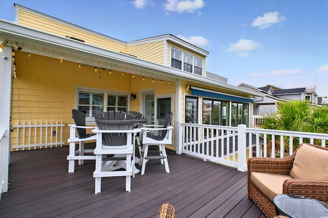 39 Newport St, Ocean Isle Beach, NC 28469 - wooden deck featuring a sunroom and outdoor dining area