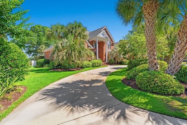 1119 Links Rd, Myrtle Beach, SC 29575 - obstructed view of property with a front lawn, driveway, and brick siding