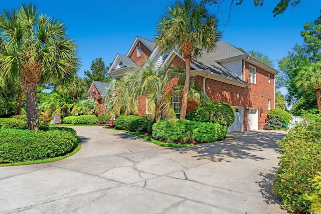 1119 Links Rd, Myrtle Beach, SC 29575 - view of property hidden behind natural elements featuring concrete driveway, brick siding, and an attached garage