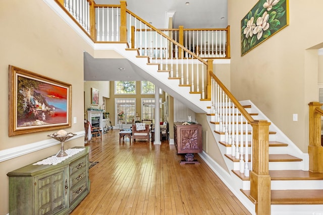 1119 Links Rd, Myrtle Beach, SC 29575 - staircase featuring a towering ceiling, hardwood / wood-style floors, and baseboards