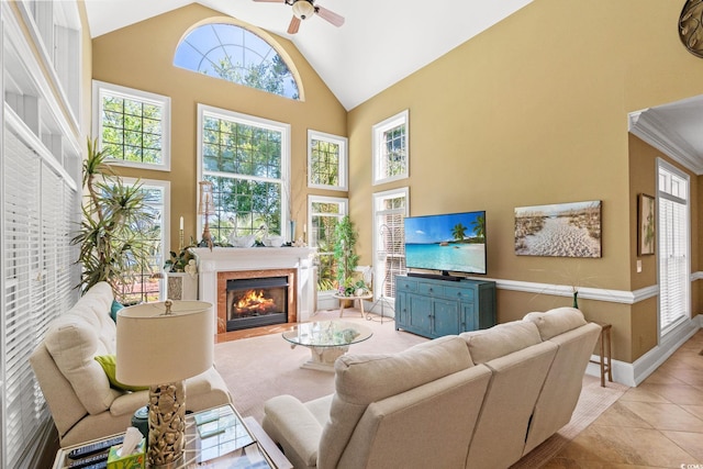 1119 Links Rd, Myrtle Beach, SC 29575 - living room featuring a ceiling fan, a glass covered fireplace, light tile patterned floors, high vaulted ceiling, and baseboards