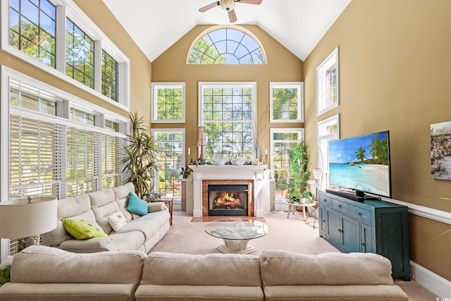 1119 Links Rd, Myrtle Beach, SC 29575 - carpeted living room featuring ceiling fan, a fireplace with flush hearth, high vaulted ceiling, and baseboards