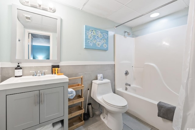 201 74th Ave N Unit 2243/2244, Myrtle Beach, SC 29572 - bathroom featuring tile walls, shower / bathtub combination with curtain, vanity, tile patterned floors, and toilet
