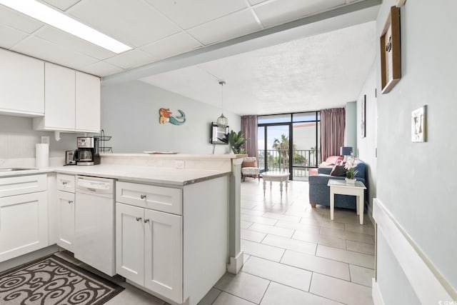 201 74th Ave N Unit 2243/2244, Myrtle Beach, SC 29572 - kitchen featuring dishwasher, open floor plan, floor to ceiling windows, a peninsula, and white cabinets