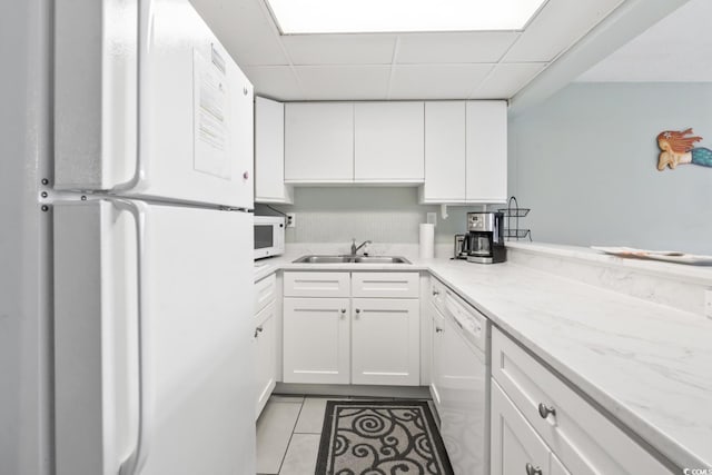 201 74th Ave N Unit 2243/2244, Myrtle Beach, SC 29572 - kitchen with white appliances, a sink, white cabinets, light tile patterned flooring, and a drop ceiling