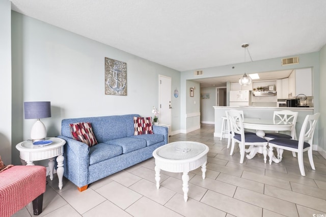 201 74th Ave N Unit 2243/2244, Myrtle Beach, SC 29572 - living area with baseboards and light tile patterned flooring