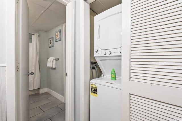 201 74th Ave N Unit 2243/2244, Myrtle Beach, SC 29572 - laundry room with stacked washer and clothes dryer, baseboards, and tile patterned flooring