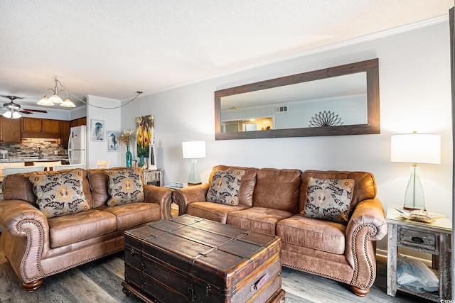 6000 N Ocean Blvd Unit 329, North Myrtle Beach, SC 29582 - living area featuring wood finished floors, ornamental molding, a ceiling fan, and a textured ceiling
