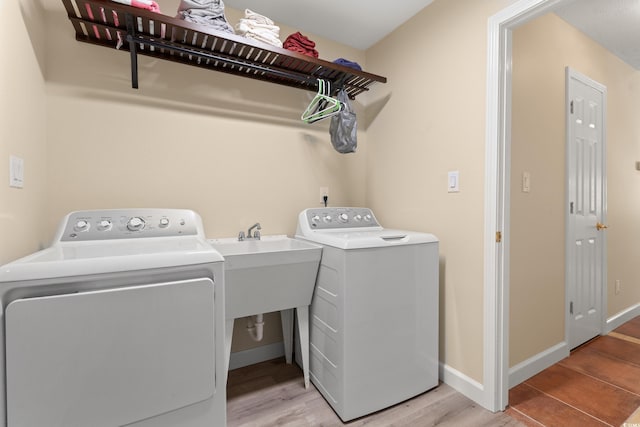 3721 Ed Smith Ave, Myrtle Beach, SC 29588 - laundry room featuring washing machine and dryer, light wood-style flooring, and baseboards