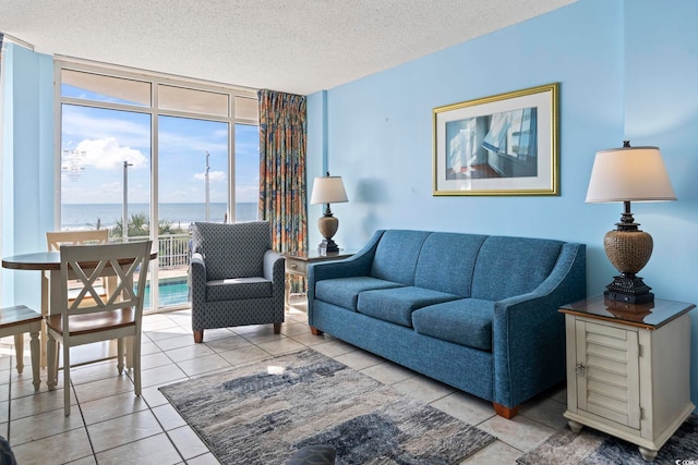 1708 N Ocean Blvd Unit 101, Myrtle Beach, SC 29577 - living room with floor to ceiling windows, a textured ceiling, and a water view