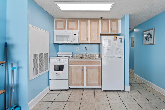 1708 N Ocean Blvd Unit 101, Myrtle Beach, SC 29577 - kitchen featuring white appliances, light brown cabinetry, a sink, a textured ceiling, and light tile patterned floors