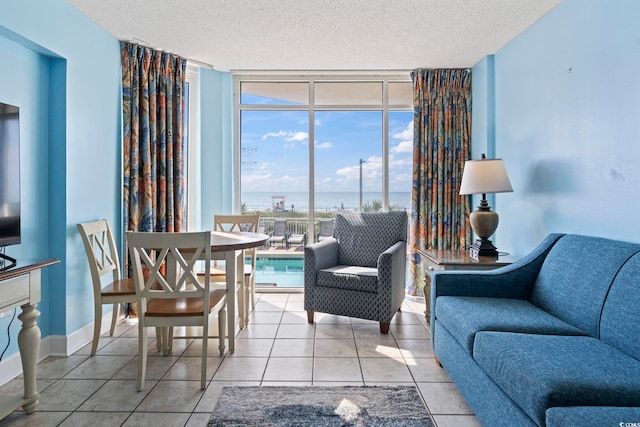 1708 N Ocean Blvd Unit 101, Myrtle Beach, SC 29577 - living area with floor to ceiling windows, a textured ceiling, a water view, and light tile patterned flooring