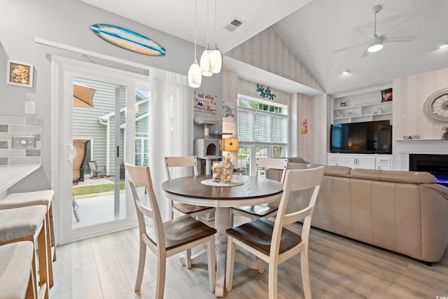 503 20th Ave N Unit 55B, North Myrtle Beach, SC 29582 - dining space with vaulted ceiling, light wood-type flooring, ceiling fan, a lit fireplace, and built in features
