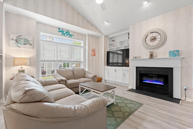 503 20th Ave N Unit 55B, North Myrtle Beach, SC 29582 - living room with vaulted ceiling, wallpapered walls, ceiling fan, light wood finished floors, and built in shelves