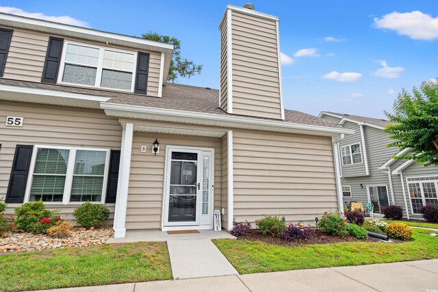 503 20th Ave N Unit 55B, North Myrtle Beach, SC 29582 - view of front of home featuring a chimney and roof with shingles