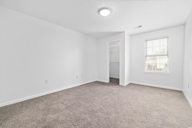 3762 Citation Way Unit 1023, Myrtle Beach, SC 29577 - unfurnished bedroom with carpet flooring, baseboards, a spacious closet, and a closet