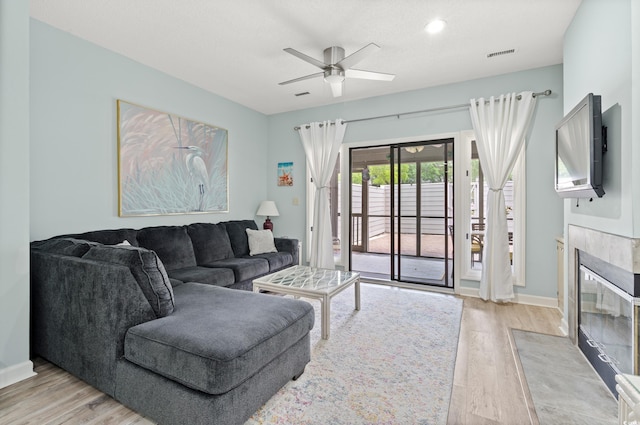 435 Ocean Creek Dr Unit 2722, Myrtle Beach, SC 29572 - living area featuring a fireplace, a ceiling fan, light wood-type flooring, and baseboards