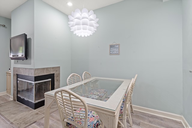 435 Ocean Creek Dr Unit 2722, Myrtle Beach, SC 29572 - dining space featuring wood finished floors, baseboards, recessed lighting, a tiled fireplace, and a chandelier