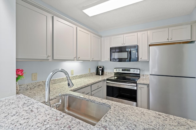 435 Ocean Creek Dr Unit 2722, Myrtle Beach, SC 29572 - kitchen with stainless steel appliances, a sink, and light stone counters