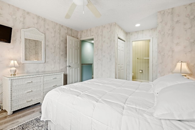435 Ocean Creek Dr Unit 2722, Myrtle Beach, SC 29572 - bedroom featuring wallpapered walls, wood finished floors, a ceiling fan, and ensuite bath