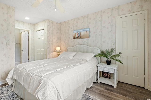 435 Ocean Creek Dr Unit 2722, Myrtle Beach, SC 29572 - bedroom with wallpapered walls, wood finished floors, a textured ceiling, ceiling fan, and a closet