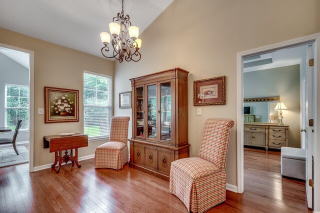 24 Willowbend Dr, Murrells Inlet, SC 29576 - sitting room with lofted ceiling, wood finished floors, plenty of natural light, and a chandelier