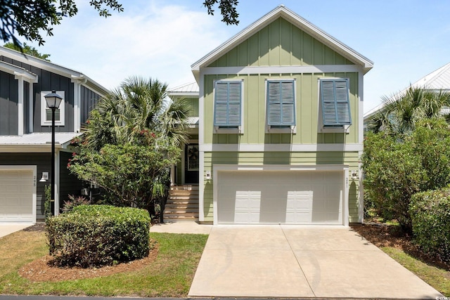 281 Lumbee Cir, Pawleys Island, SC 29585 - view of front facade with board and batten siding, a garage, and driveway