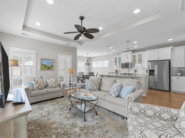 281 Lumbee Cir, Pawleys Island, SC 29585 - living room featuring a raised ceiling, light wood finished floors, recessed lighting, and ceiling fan