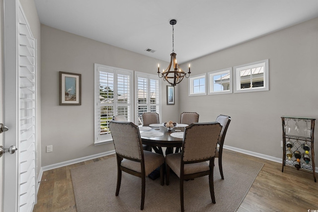 281 Lumbee Cir, Pawleys Island, SC 29585 - dining area with a chandelier, wood finished floors, and baseboards