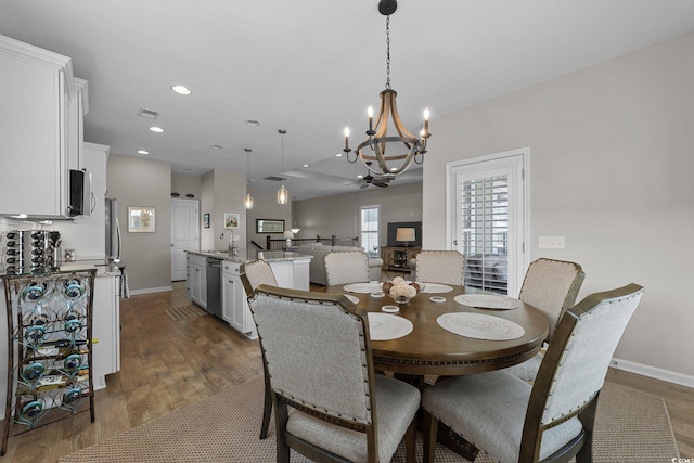 281 Lumbee Cir, Pawleys Island, SC 29585 - dining space with dark wood-style floors, a chandelier, baseboards, and recessed lighting