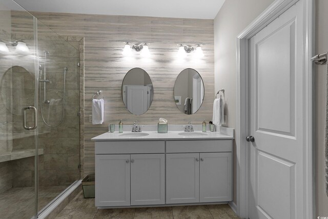 281 Lumbee Cir, Pawleys Island, SC 29585 - bathroom with double vanity, a shower stall, and tile patterned floors