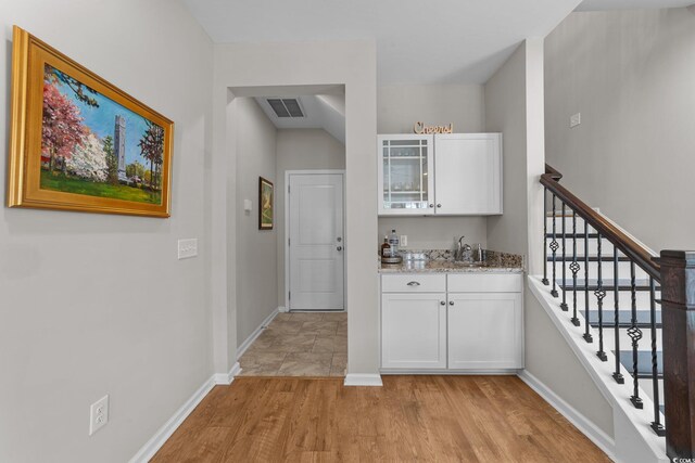 281 Lumbee Cir, Pawleys Island, SC 29585 - indoor wet bar with light wood-style floors, baseboards, and stairway