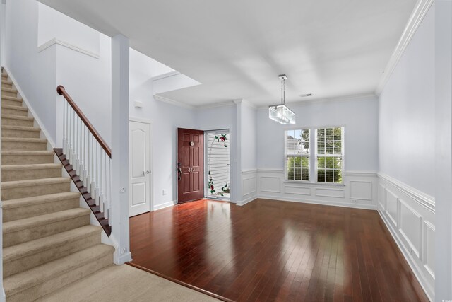 373 Skyland Pines Dr, Myrtle Beach, SC 29588 - foyer featuring dark wood-style floors, stairs, a chandelier, wainscoting, and ornamental molding