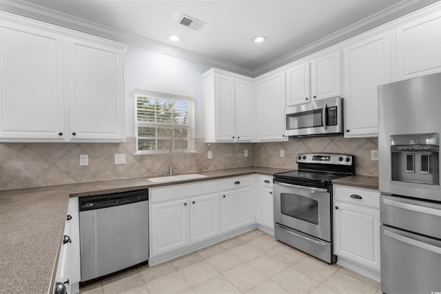 373 Skyland Pines Dr, Myrtle Beach, SC 29588 - kitchen with appliances with stainless steel finishes, a sink, white cabinets, tasteful backsplash, and dark countertops