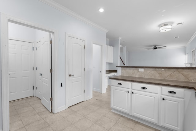 373 Skyland Pines Dr, Myrtle Beach, SC 29588 - kitchen featuring crown molding, dark countertops, white cabinetry, a ceiling fan, and baseboards