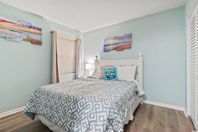920 N Waccamaw Dr Unit 1302, Garden City Beach, SC 29576 - bedroom featuring wood finished floors, baseboards, and a textured ceiling