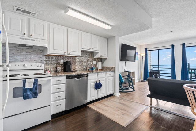920 N Waccamaw Dr Unit 1302, Garden City Beach, SC 29576 - kitchen with stainless steel dishwasher, electric stove, under cabinet range hood, wood finished floors, and a textured ceiling