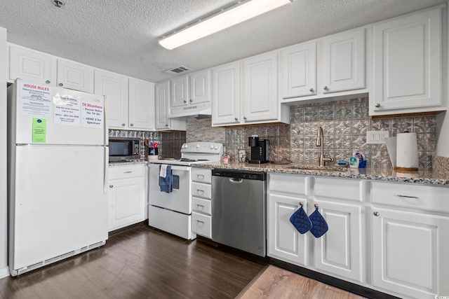 920 N Waccamaw Dr Unit 1302, Garden City Beach, SC 29576 - kitchen with stainless steel appliances, a sink, white cabinets, under cabinet range hood, and a textured ceiling