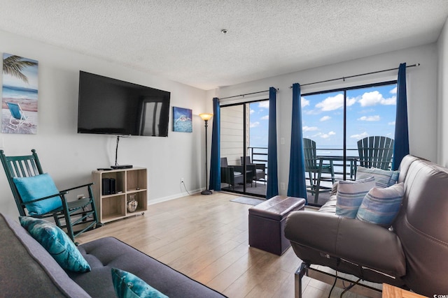 920 N Waccamaw Dr Unit 1302, Garden City Beach, SC 29576 - living room with a textured ceiling, wood finished floors, and baseboards