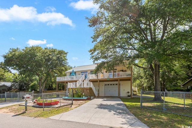 3926 Flagg St, Murrells Inlet, SC 29576 - view of front of house with stairs, an attached garage, and concrete driveway