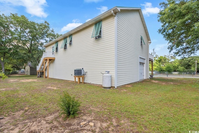 3926 Flagg St, Murrells Inlet, SC 29576 - view of property exterior with an attached garage, central air condition unit, stairs, and a wooden deck