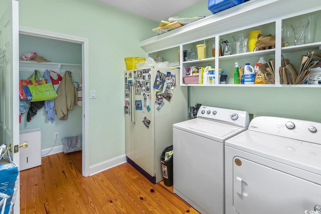 3926 Flagg St, Murrells Inlet, SC 29576 - laundry area with separate washer and dryer, light wood-style flooring, and baseboards