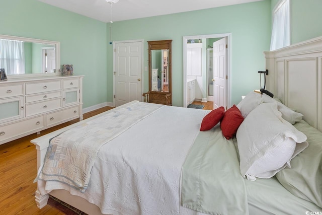3926 Flagg St, Murrells Inlet, SC 29576 - bedroom featuring light wood-type flooring, baseboards, and ensuite bathroom