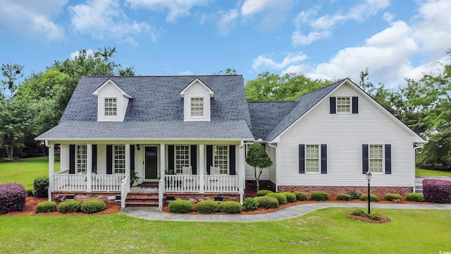 412 Carolina Dr, Loris, SC 29569 - new england style home with covered porch, crawl space, a front lawn, and a shingled roof