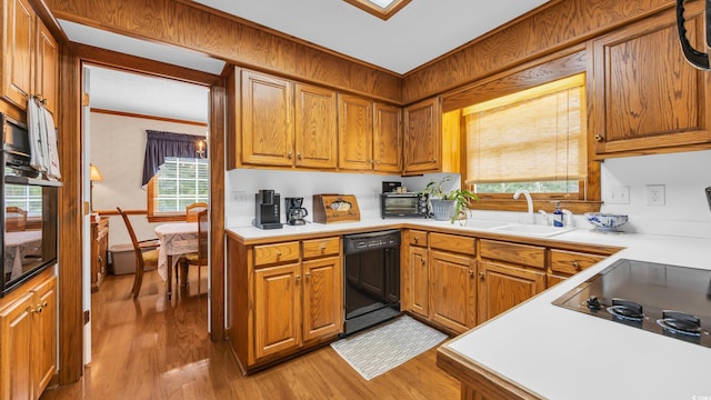 412 Carolina Dr, Loris, SC 29569 - kitchen with black dishwasher, light wood-style flooring, light countertops, brown cabinets, and oven