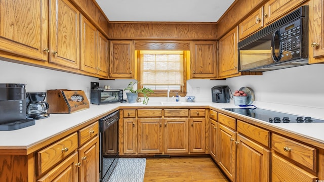 412 Carolina Dr, Loris, SC 29569 - kitchen with black appliances, brown cabinetry, and light countertops