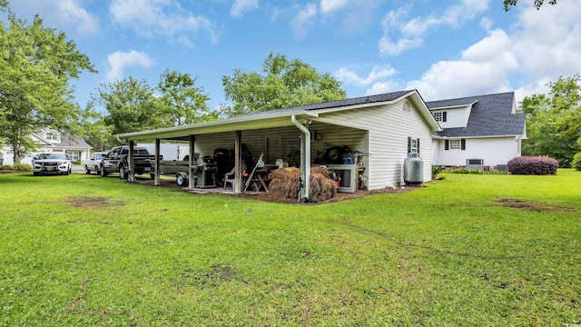 412 Carolina Dr, Loris, SC 29569 - back of house featuring a lawn, a shingled roof, and a carport