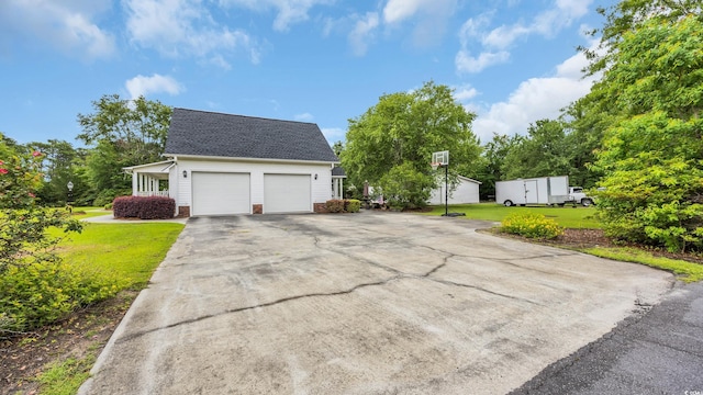 412 Carolina Dr, Loris, SC 29569 - view of front of house with a front lawn, an attached garage, driveway, and roof with shingles
